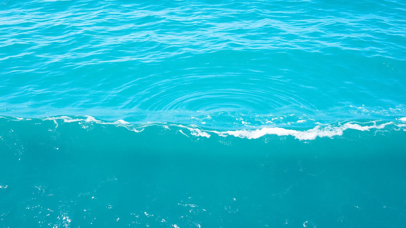 Bright turquoise ocean surface with gentle waves and expanding ripples